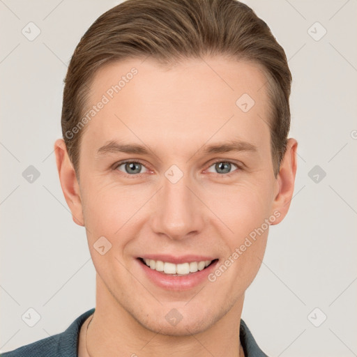 Joyful white young-adult male with short  brown hair and grey eyes