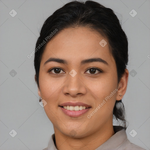 Joyful latino young-adult female with medium  brown hair and brown eyes