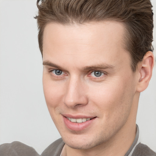 Joyful white young-adult male with short  brown hair and brown eyes