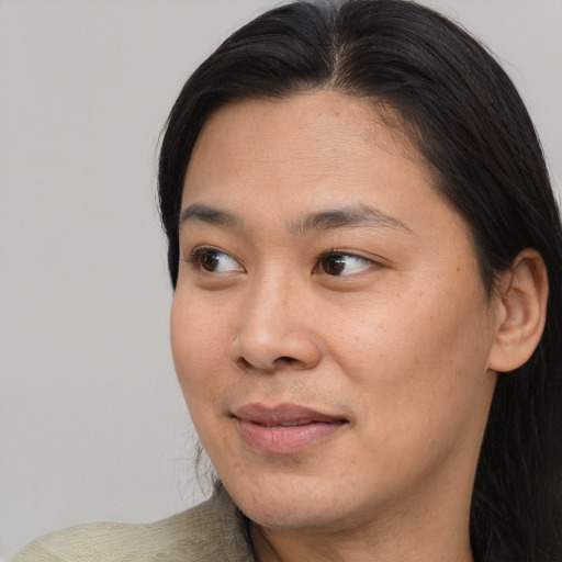 Joyful asian young-adult female with medium  brown hair and brown eyes