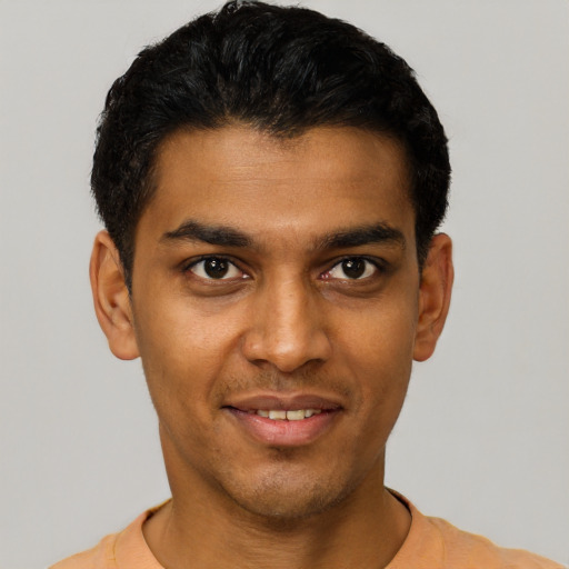 Joyful latino young-adult male with short  black hair and brown eyes