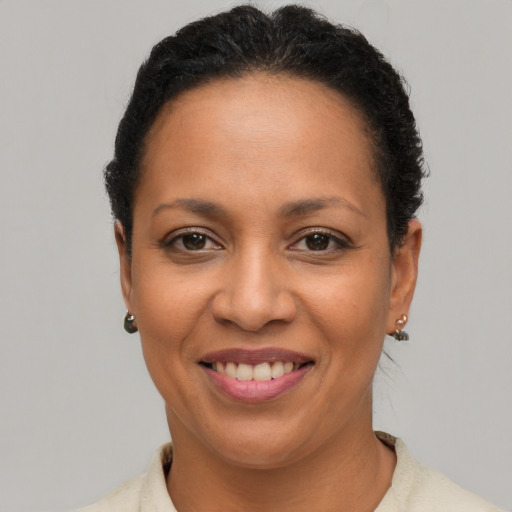 Joyful latino adult female with short  brown hair and brown eyes