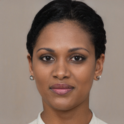 Joyful black young-adult female with short  black hair and brown eyes