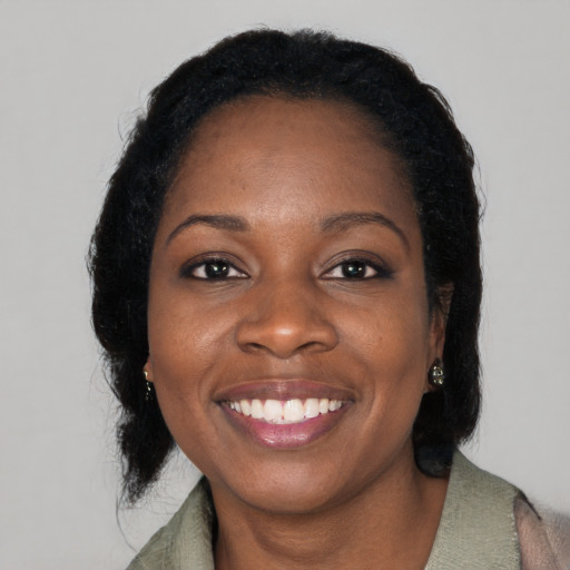 Joyful black young-adult female with medium  black hair and brown eyes