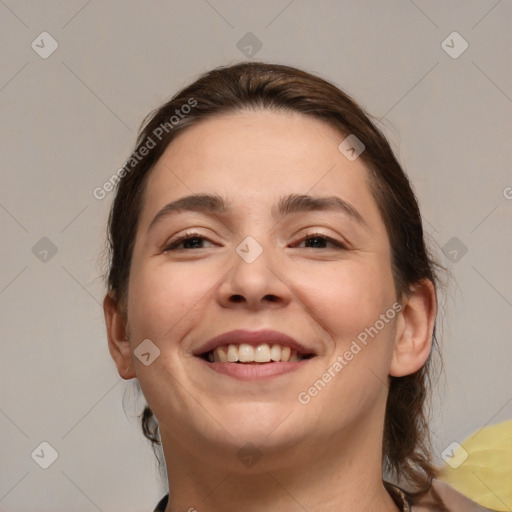 Joyful white adult female with medium  brown hair and brown eyes