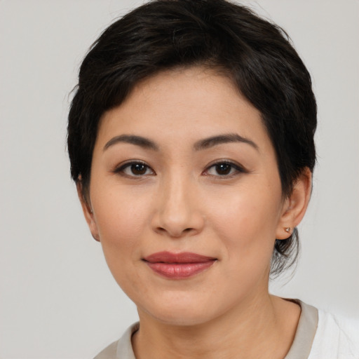 Joyful asian young-adult female with short  black hair and brown eyes