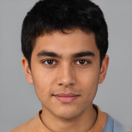 Joyful latino young-adult male with short  brown hair and brown eyes