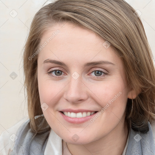 Joyful white young-adult female with medium  brown hair and blue eyes