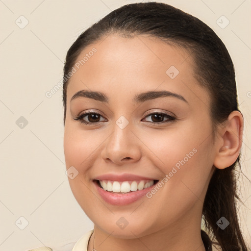 Joyful white young-adult female with long  brown hair and brown eyes