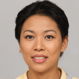 Joyful asian young-adult female with short  brown hair and brown eyes