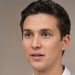 Joyful white adult male with short  brown hair and brown eyes