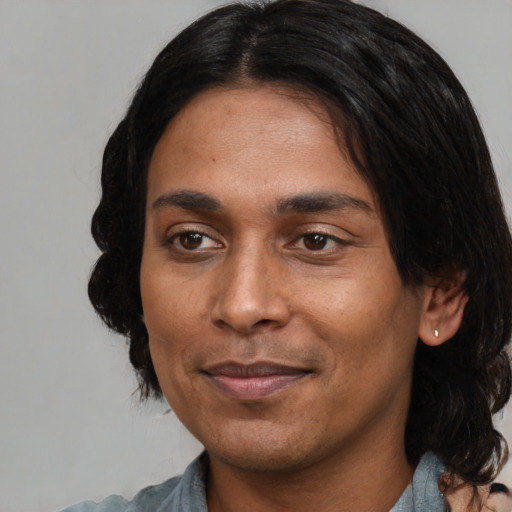 Joyful black young-adult male with medium  black hair and brown eyes