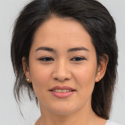 Joyful asian young-adult female with medium  brown hair and brown eyes