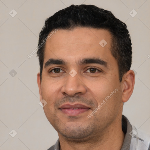 Joyful white young-adult male with short  black hair and brown eyes