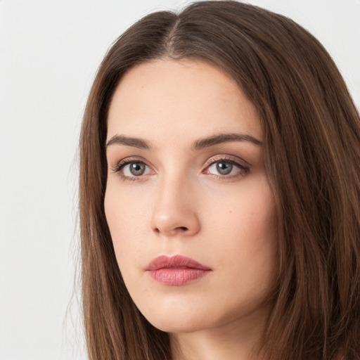 Neutral white young-adult female with long  brown hair and brown eyes