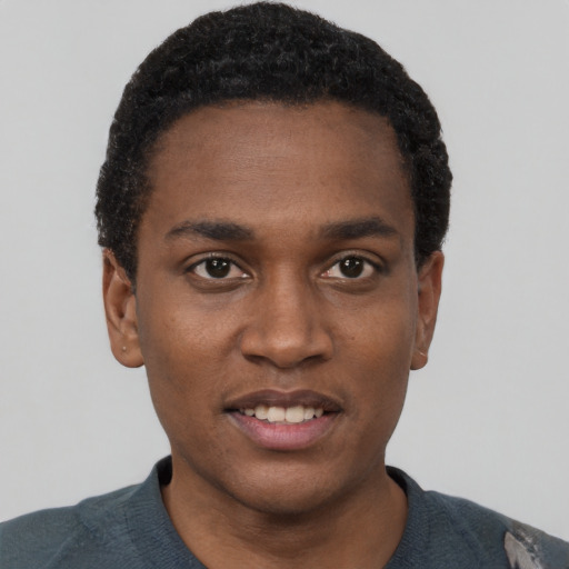 Joyful black young-adult male with short  black hair and brown eyes