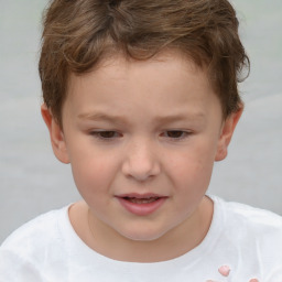 Joyful white child male with short  brown hair and brown eyes