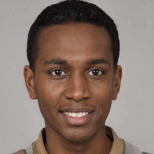 Joyful black young-adult male with short  black hair and brown eyes