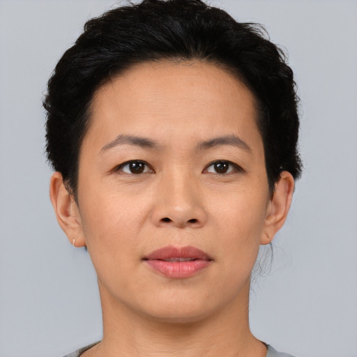 Joyful asian adult female with short  brown hair and brown eyes