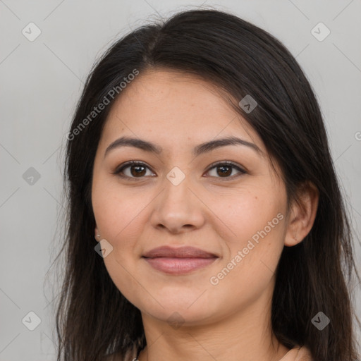 Joyful latino young-adult female with long  brown hair and brown eyes