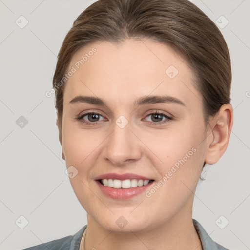 Joyful white young-adult female with medium  brown hair and grey eyes