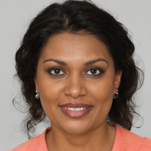 Joyful black young-adult female with medium  brown hair and brown eyes