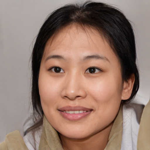 Joyful asian young-adult female with medium  brown hair and brown eyes