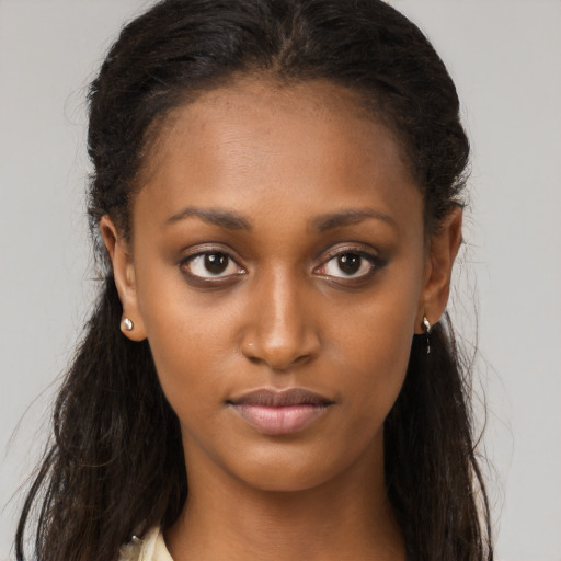 Neutral black young-adult female with long  brown hair and brown eyes