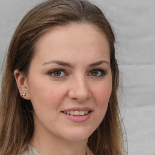 Joyful white young-adult female with long  brown hair and grey eyes