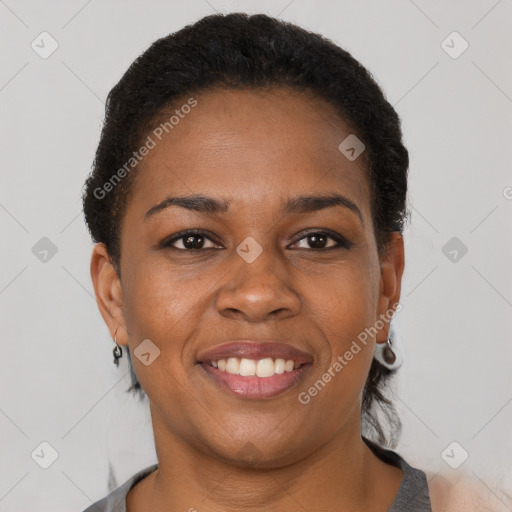 Joyful black adult female with short  brown hair and brown eyes