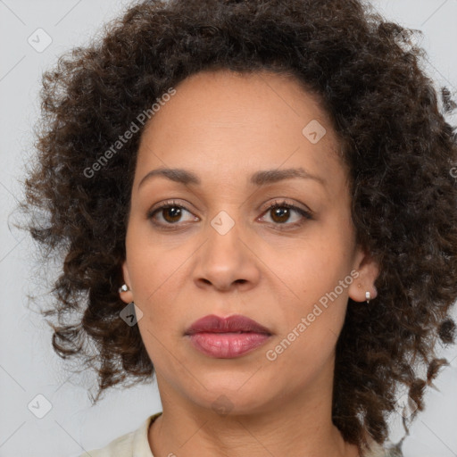 Joyful black adult female with medium  brown hair and brown eyes