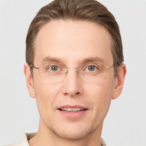 Joyful white adult male with short  brown hair and grey eyes