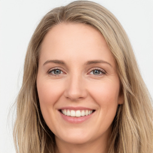 Joyful white young-adult female with long  brown hair and green eyes