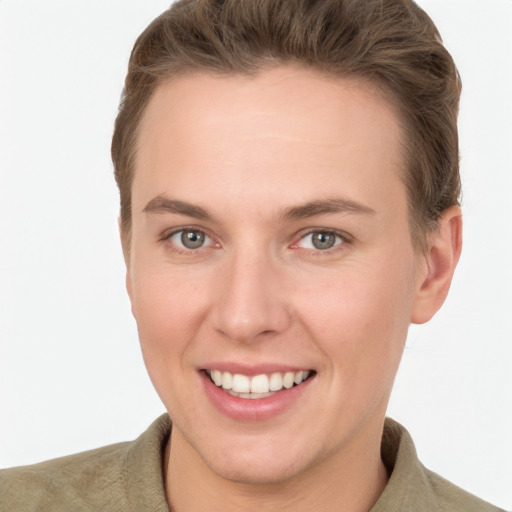 Joyful white young-adult female with short  brown hair and grey eyes