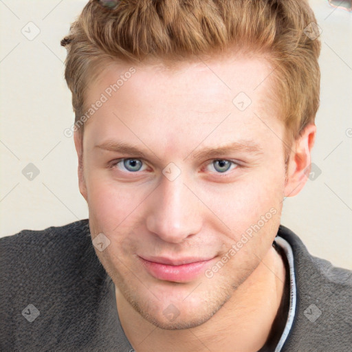 Joyful white young-adult male with short  brown hair and blue eyes