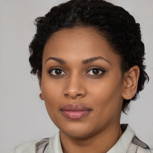 Joyful black young-adult female with medium  black hair and brown eyes
