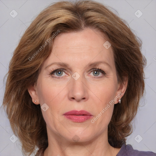 Joyful white adult female with medium  brown hair and blue eyes