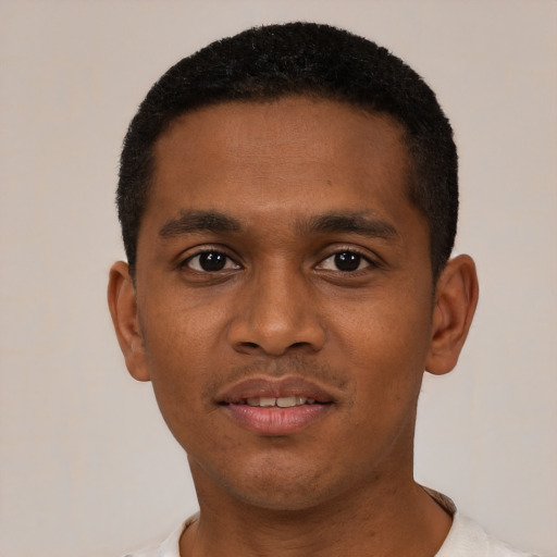 Joyful black young-adult male with short  black hair and brown eyes