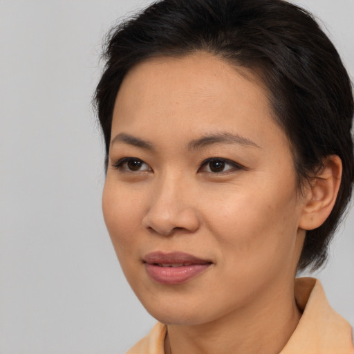 Joyful asian young-adult female with medium  brown hair and brown eyes