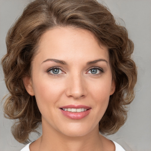 Joyful white young-adult female with medium  brown hair and green eyes