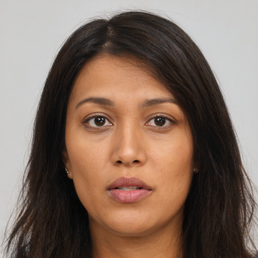 Neutral latino young-adult female with long  brown hair and brown eyes
