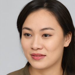 Joyful asian young-adult female with long  brown hair and brown eyes