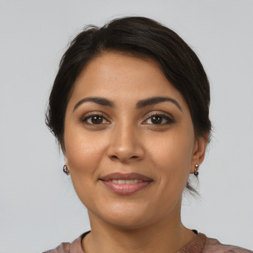 Joyful latino young-adult female with short  brown hair and brown eyes