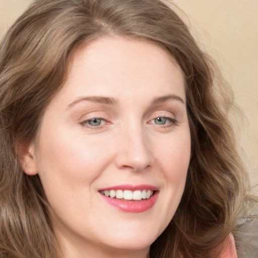 Joyful white young-adult female with long  brown hair and green eyes