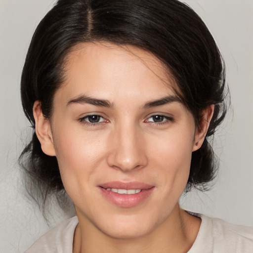 Joyful white young-adult female with medium  brown hair and brown eyes