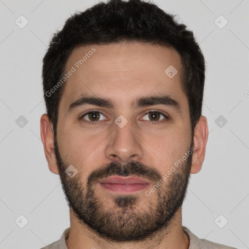 Joyful white young-adult male with short  black hair and brown eyes