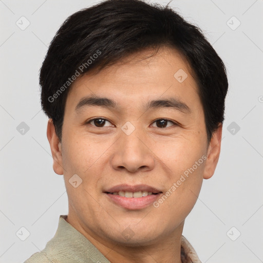 Joyful asian young-adult male with short  brown hair and brown eyes