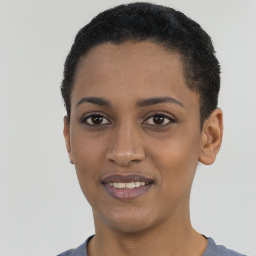 Joyful black young-adult female with short  black hair and brown eyes