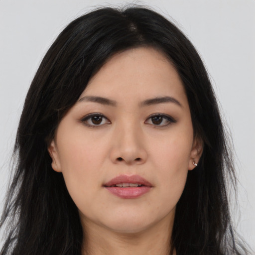 Joyful asian young-adult female with long  black hair and brown eyes