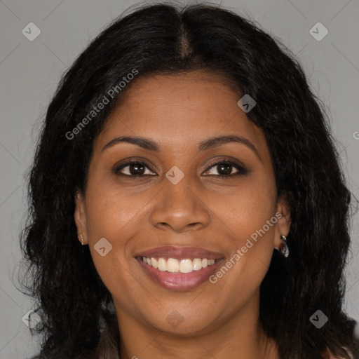 Joyful black young-adult female with long  brown hair and brown eyes